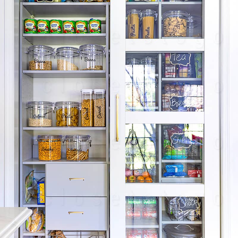 Reach in white linen closet with drawers and shelves.