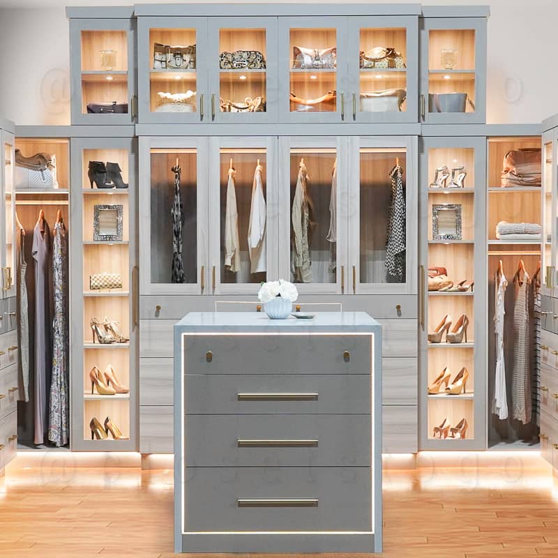 Grey LED luxury walk in closet with glass doors to display shoes.