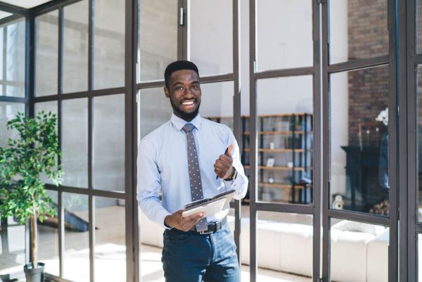 Full service on site visit, man with clipboard in a house.